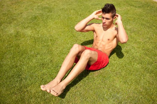 young handsome man making abs workout