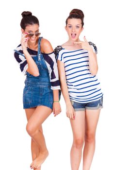 portrait of two young beautiful friends playing and having fun on white background