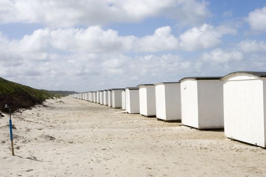 Row of White boathouses on the beach