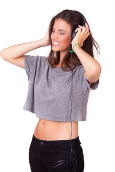 young beautiful women listening music on headphones, on white background, while laughing