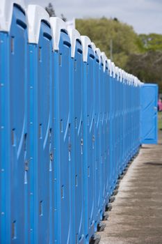 Row of Blue Portable Toilets