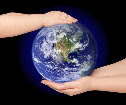 Child and woman holds earth globe on black