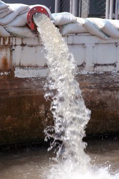 drain water pipe on waterside pointed to the river 