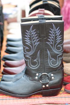 a line of black cowboy boots