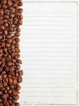 Coffee beans on white paper background for notes 