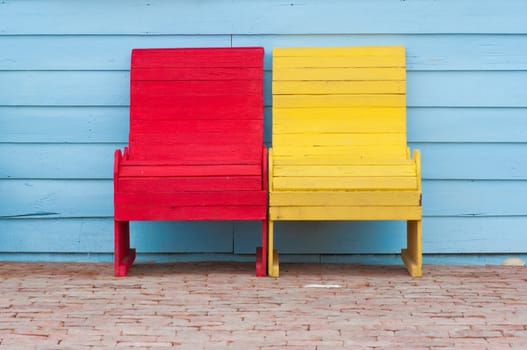 red and yellow chairs on ancient red brick