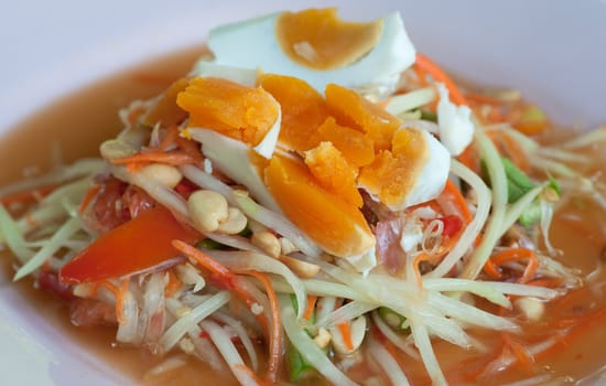 dish of papaya salad with salted eggs