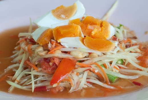 dish of papaya salad with salted eggs