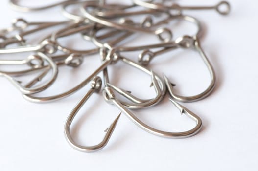 Stainless steel fishing hook on white 