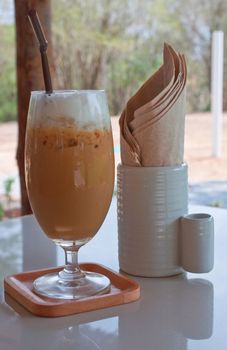 a glass of ice coffee on the table