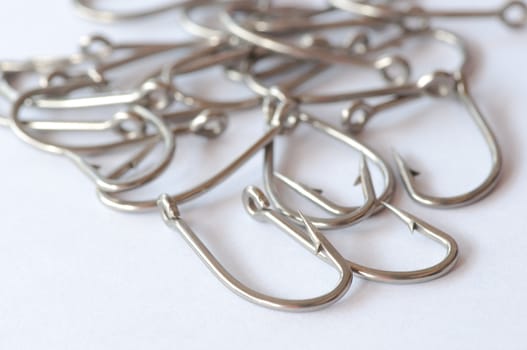 Stainless steel fishing hook on white 