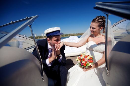 captain kissing hand to a lady on the yacht