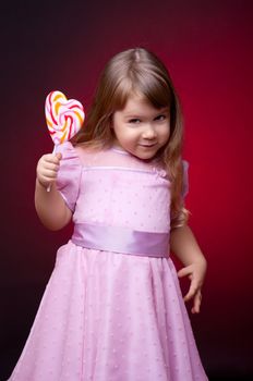 Little smiling girl with lollipop