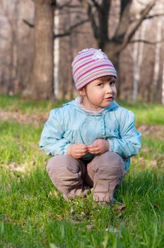 Little smiling little girl at spring forest