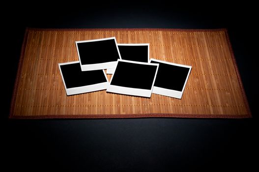 Blank photo frames on bamboo napkin