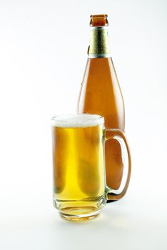 bottle and glass of beer on white background