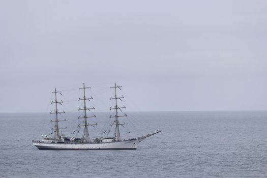 Sailing vessel "Nadezhda" in the sea in the cloudy afternoon