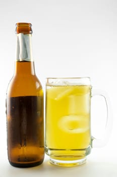 bottle and glass of beer on white background