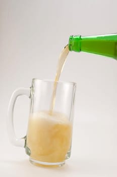 bottle and glass of beer on white background