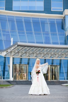 happy bride near the modern building
