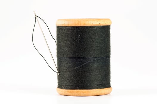 Spool of thread with needle  on white background