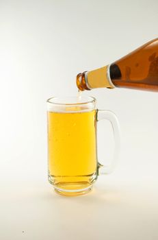 bottle and glass of beer on white background