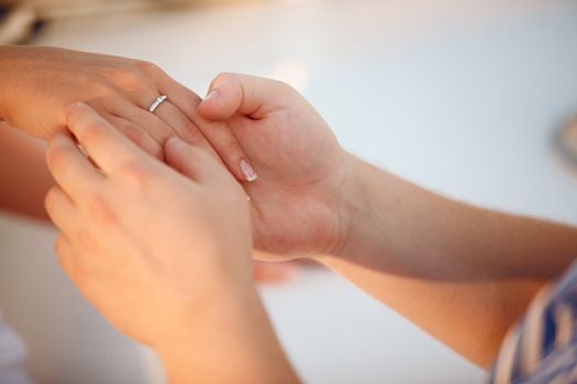 girls hand with ring in hands of a man
