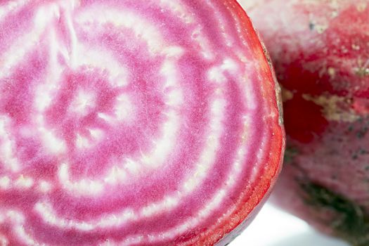 Close up of candy beetroot with distinctive red and white pattern.
