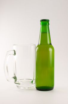bottle and glass of beer on white background