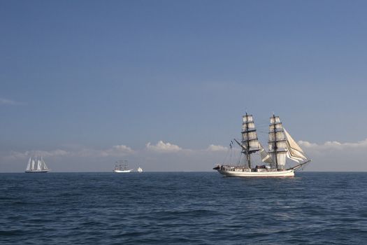 Ship with white sails in the calm sea