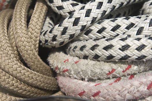 Close-up of thick textile ropes laying on a ship's deck
