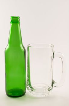 bottle and glass of beer on white background
