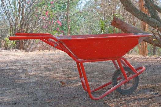 single wheel construction orange pushcart 