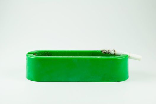 green ashtray on white background