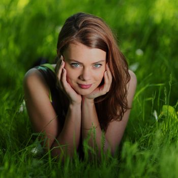 beautiful woman laying on grass