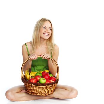 woman holds a basket of fruit