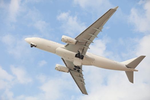 White jet aircraft in blue sky