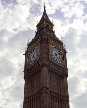 Big ben clock face in London with cloudy sky background                               
