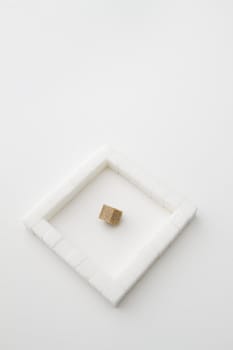 white sugar cube place in a square with on brown sugar square in the middle