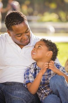 Happy African American Father and Mixed Race Son Playing in the Park.