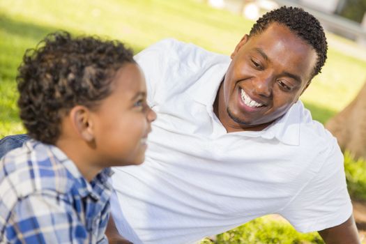 Happy African American Father and Mixed Race Son Playing in the Park.