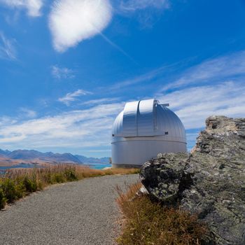 Domed astronomy observatory building housing a telescope for astronomical and meteorological observations standing on a mountain top to afford a clear view