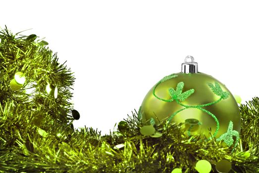 Green chrismas decorations against a withe background with space for text
