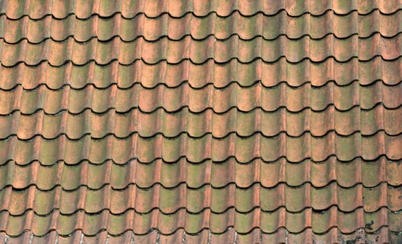 Roof of a house covered with old red tiling