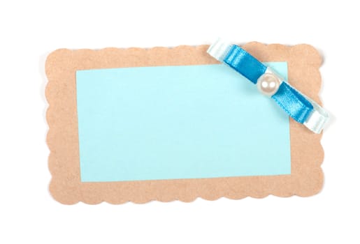 Blank gift tag tied with blue ribbon on white background