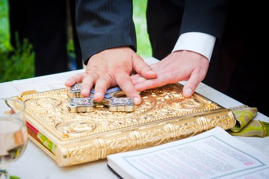 Hands on bible at a wedding ceremony