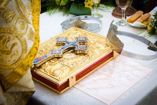 Wedding crowns and cross on a bible prepared for ceremony