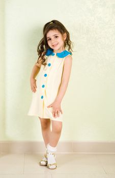 pretty girl in yellow dress with blue buttons