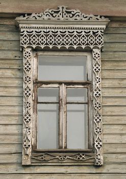 Window of an old russian house decorated with carving