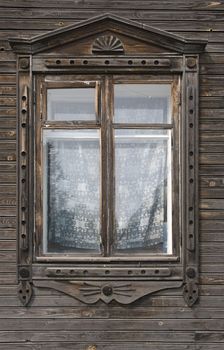 Window of an old russian house decorated with carving